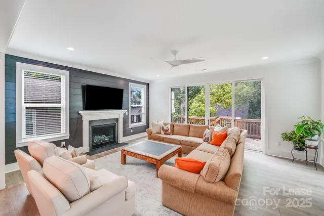 a living room with furniture a fireplace and a flat screen tv
