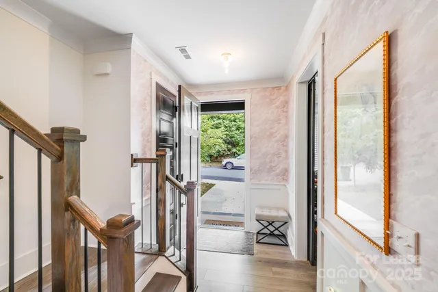 a view of entryway with wooden floor and livingroom view