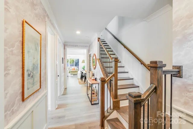 a view of hallway with wooden floor and stairs