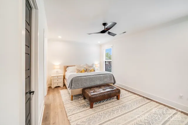 a bedroom with a bed and wooden floor