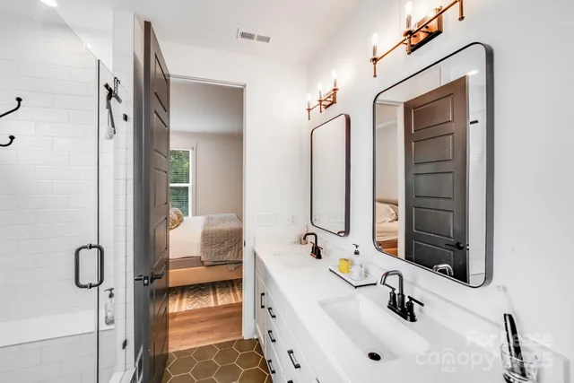 a bathroom with a tub sink and mirror