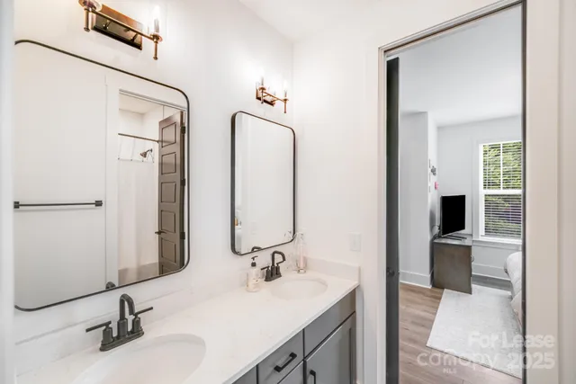 a bathroom with a double vanity sink and a mirror