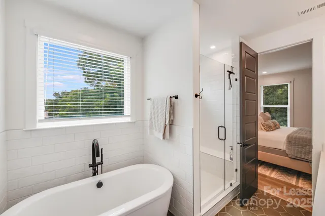 a bathroom with a tub sink and shower