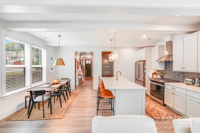a large kitchen with a table and chairs