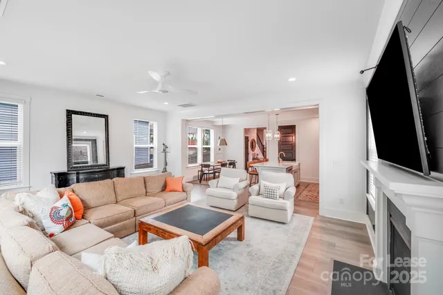 a living room with fireplace furniture and a flat screen tv