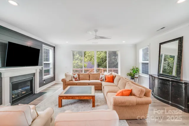 a living room with fireplace furniture and a flat screen tv