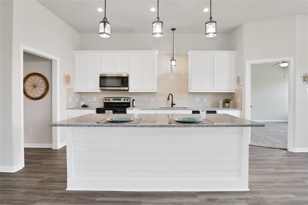 115 Panther Loop Mabank, TX 75147 - Photo 7 of 29 Oversized island with granite and custom shiplap face!