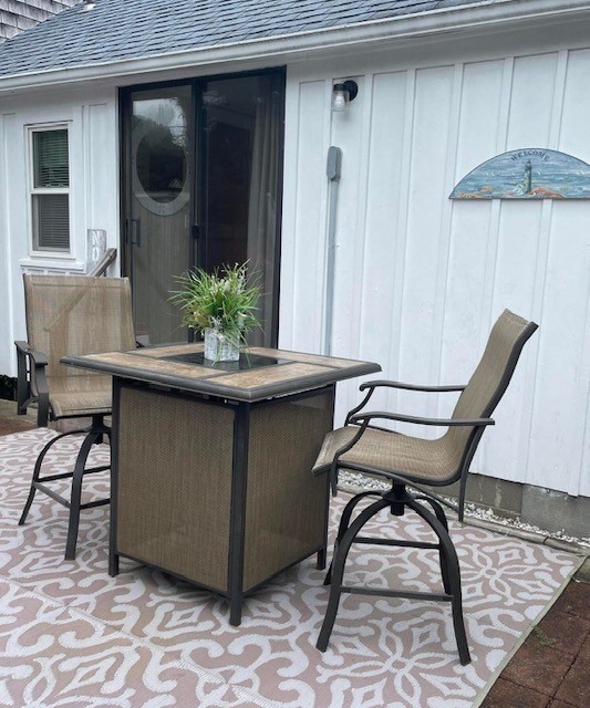 75 Beaten Road, Unit 12 Dennis, MA 02639 - Photo 17 of 26 a room with a table chairs and wooden floor