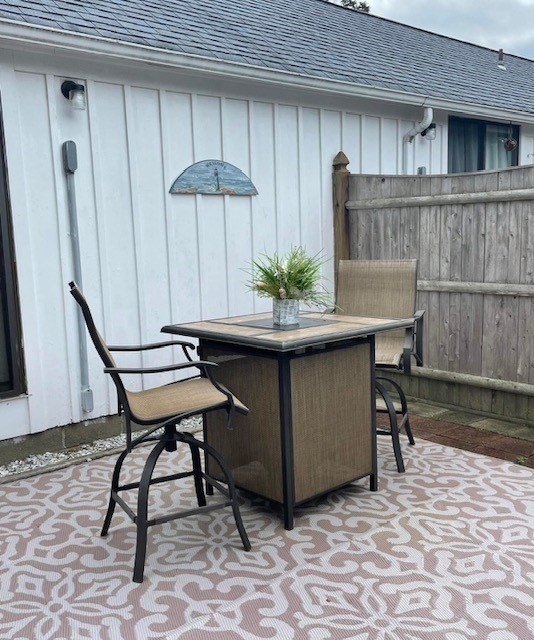 75 Beaten Road, Unit 12 Dennis, MA 02639 - Photo 18 of 26 a backyard of a house with table and chairs