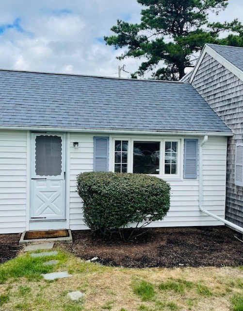 75 Beaten Road, Unit 12 Dennis, MA 02639 - Photo 3 of 26 a front view of a house with a yard