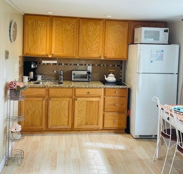 75 Beaten Road, Unit 12 Dennis, MA 02639 - Photo 5 of 26 a kitchen with a refrigerator a stove a sink and a cabinets