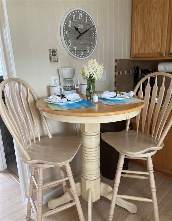 75 Beaten Road, Unit 12 Dennis, MA 02639 - Photo 7 of 26 a dining room with table chairs and a chandelier