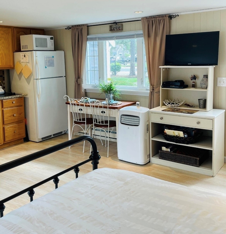 75 Beaten Road, Unit 12 Dennis, MA 02639 - Photo 8 of 26 a living room with a bed furniture and a window