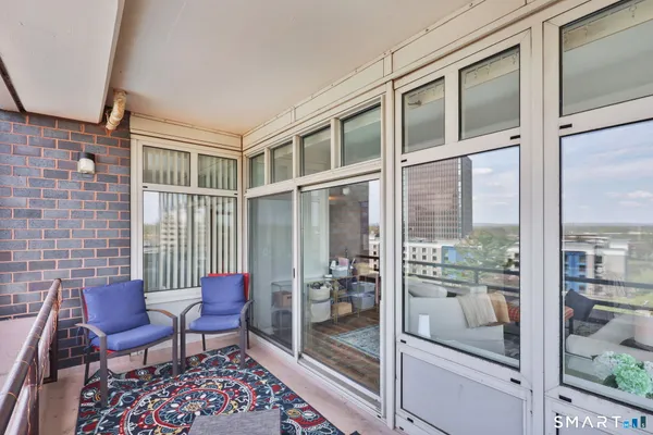 a balcony with table and chairs
