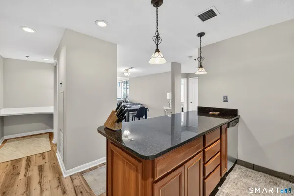 a kitchen with a sink a counter space and cabinets