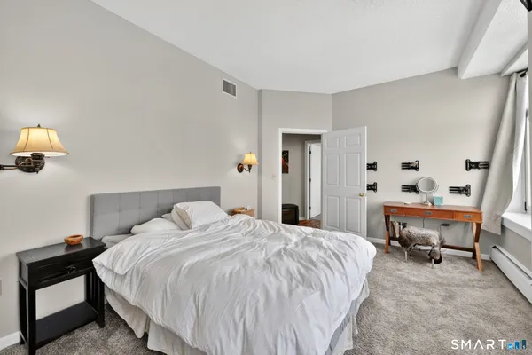 a bedroom with a bed and a table in it