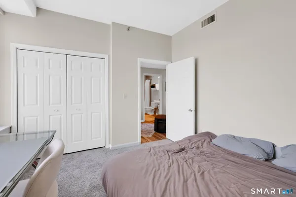a bedroom with a bed and a sink