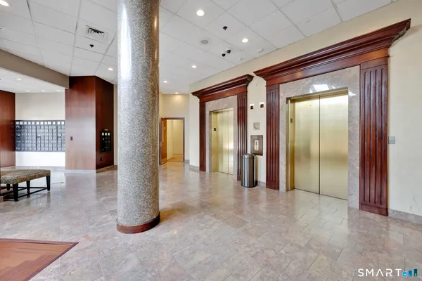 a view of a hallway with furniture