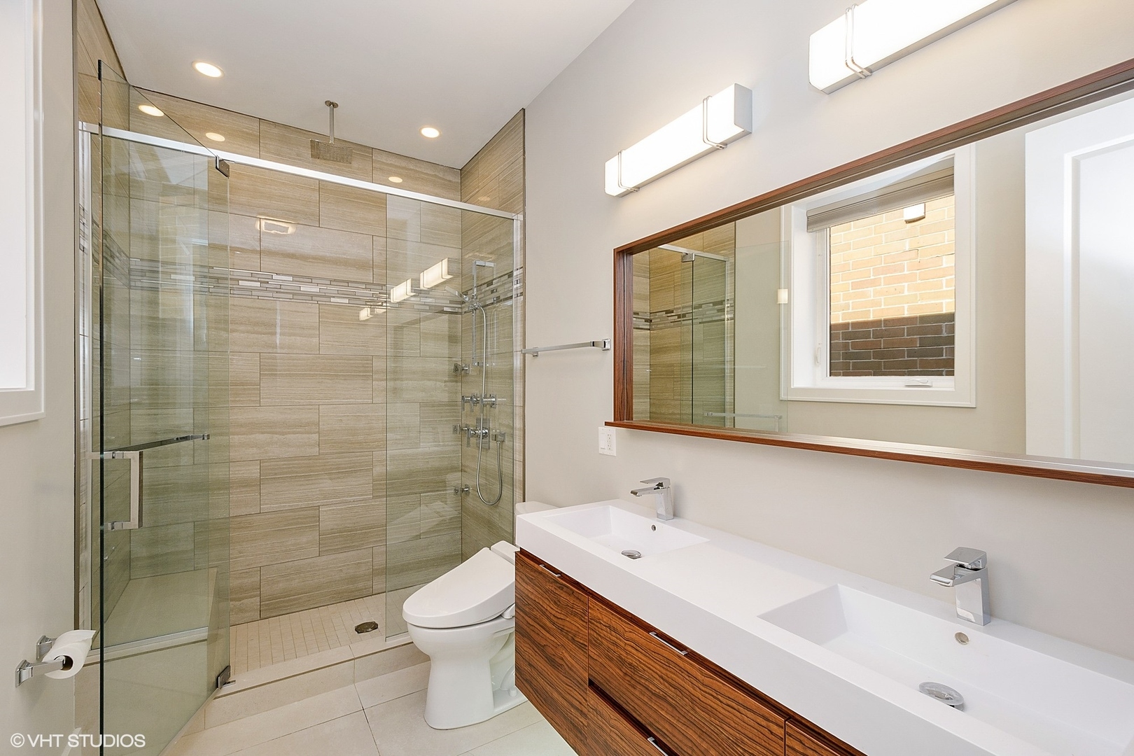 1424 West Fillmore Street, Unit 3E Chicago, IL 60607 - Photo 11 of 21 a bathroom with a double vanity sink toilet and shower