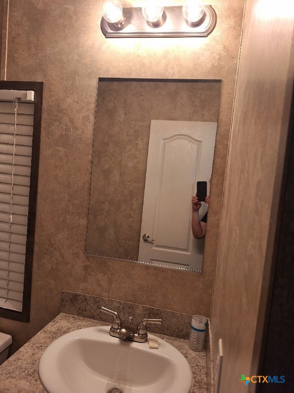 46 County Road 400 Yoakum, TX 77995 - Photo 19 of 23 a bathroom with a sink and a mirror