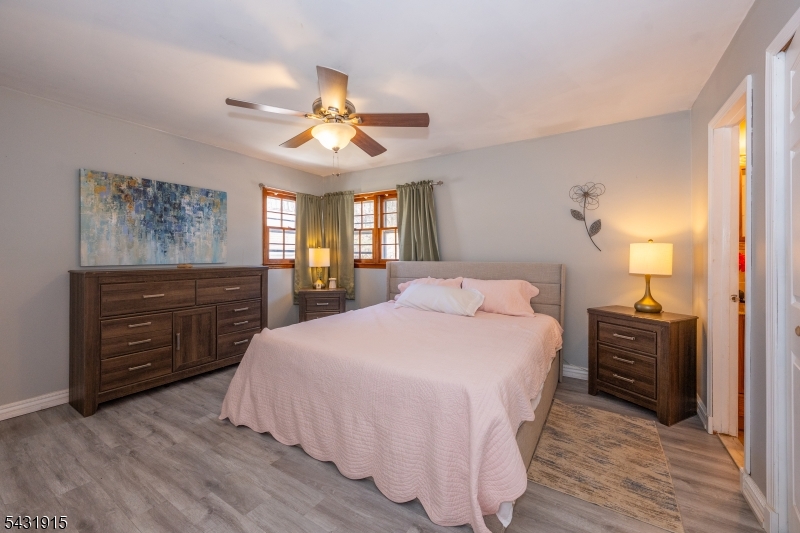 41 Waterloo Road Stanhope, NJ 07874 - Photo 14 of 32 a spacious bedroom with a bed a dresser and a chandelier