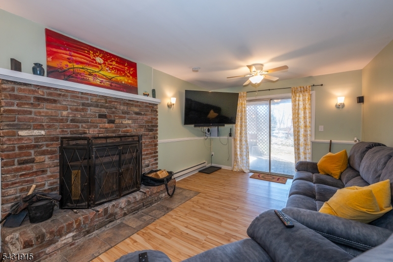 41 Waterloo Road Stanhope, NJ 07874 - Photo 20 of 32 a living room with furniture a flat screen tv and a fireplace