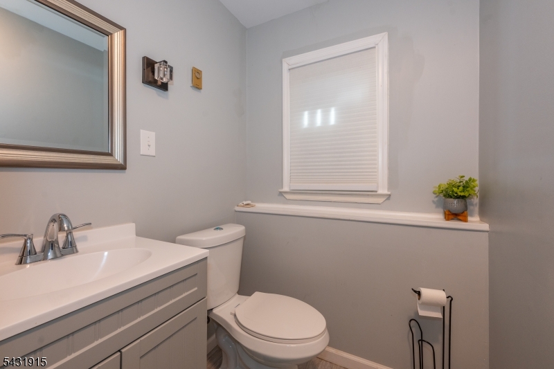 41 Waterloo Road Stanhope, NJ 07874 - Photo 24 of 32 a bathroom with a toilet a sink a mirror and vanity