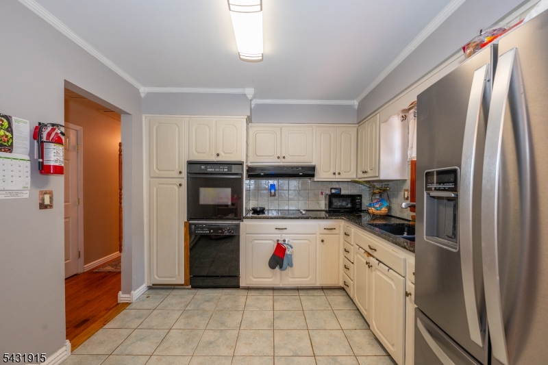41 Waterloo Road Stanhope, NJ 07874 - Photo 7 of 32 a kitchen with granite countertop a refrigerator and a sink
