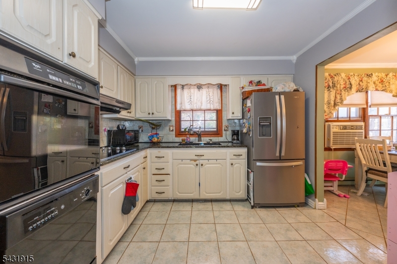 41 Waterloo Road Stanhope, NJ 07874 - Photo 8 of 32 a kitchen with a refrigerator and white cabinets