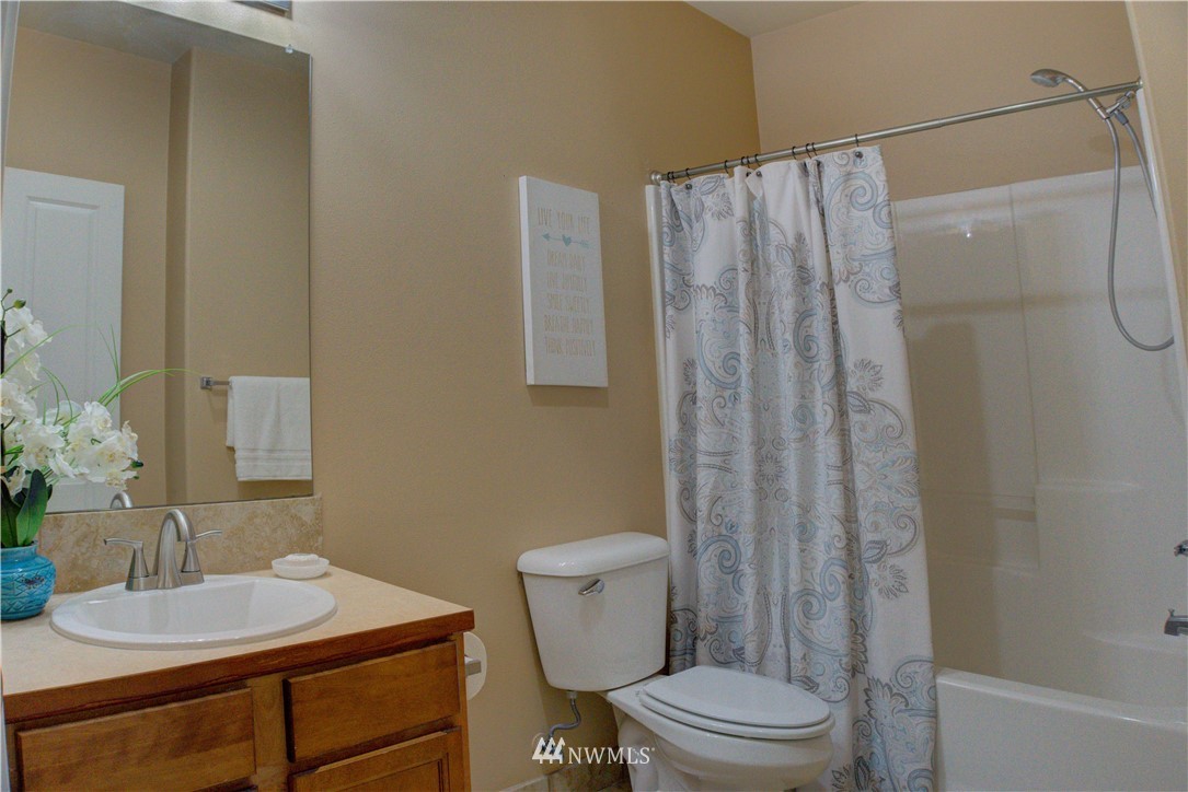 14915 38th Drive Southeast, Unit EE2029 Bothell, WA 98012 - Photo 11 of 12 a bathroom with a sink toilet and shower