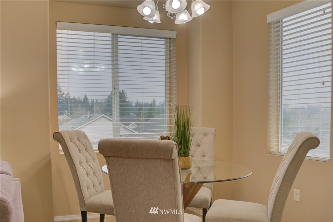 14915 38th Drive Southeast, Unit EE2029 Bothell, WA 98012 - Photo 3 of 12 a view of a dining room with furniture and windows