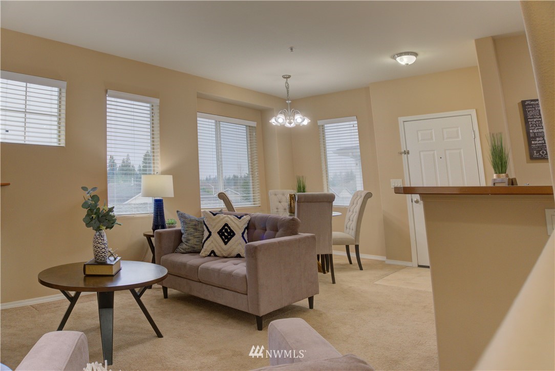 14915 38th Drive Southeast, Unit EE2029 Bothell, WA 98012 - Photo 4 of 12 a living room with furniture and a chandelier