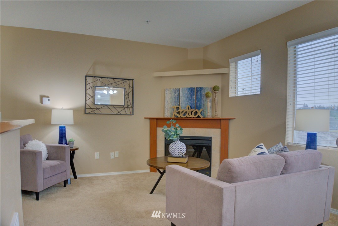 14915 38th Drive Southeast, Unit EE2029 Bothell, WA 98012 - Photo 5 of 12 a living room with furniture and a fireplace