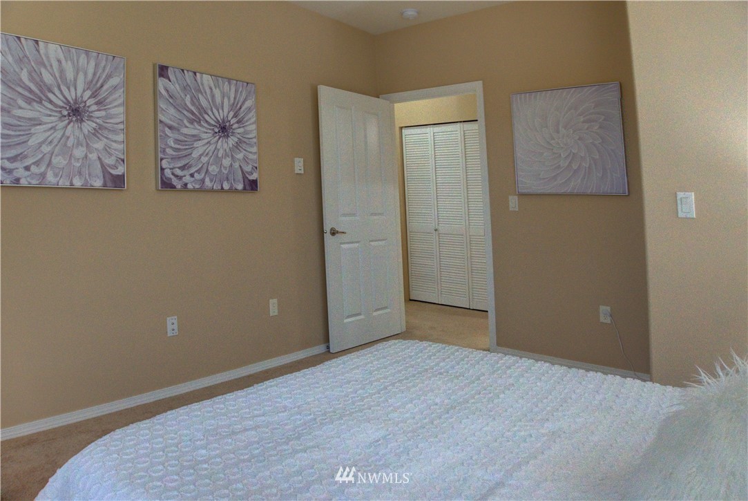 14915 38th Drive Southeast, Unit EE2029 Bothell, WA 98012 - Photo 9 of 12 an empty room with wooden floor and closet