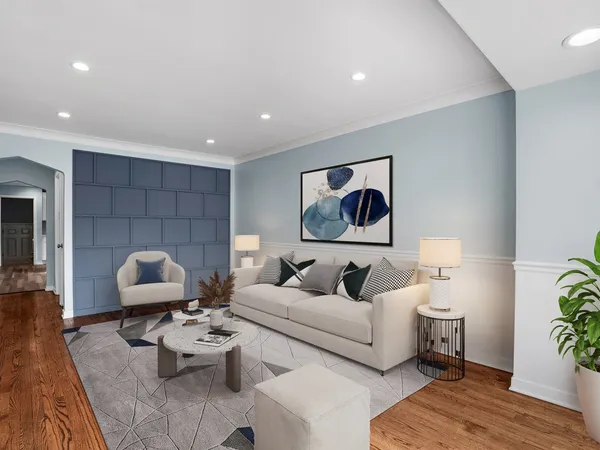 a living room with furniture and wooden floor