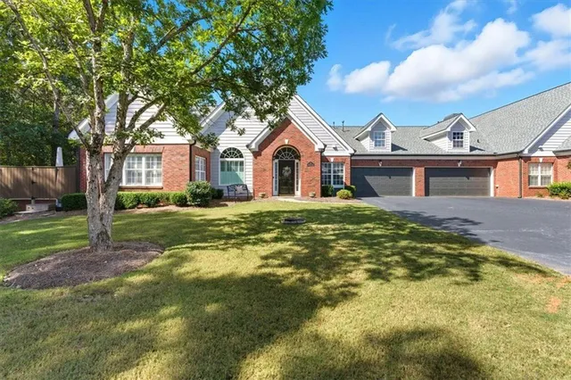 a front view of a house with a garden