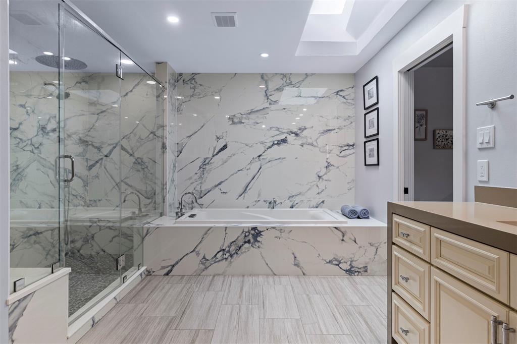 3371 Regent Drive Dallas, TX 75229 - Photo 13 of 36 Fully renovated primary bathroom with walk-in shower + separate tub + double vanity + water closet with bidet.