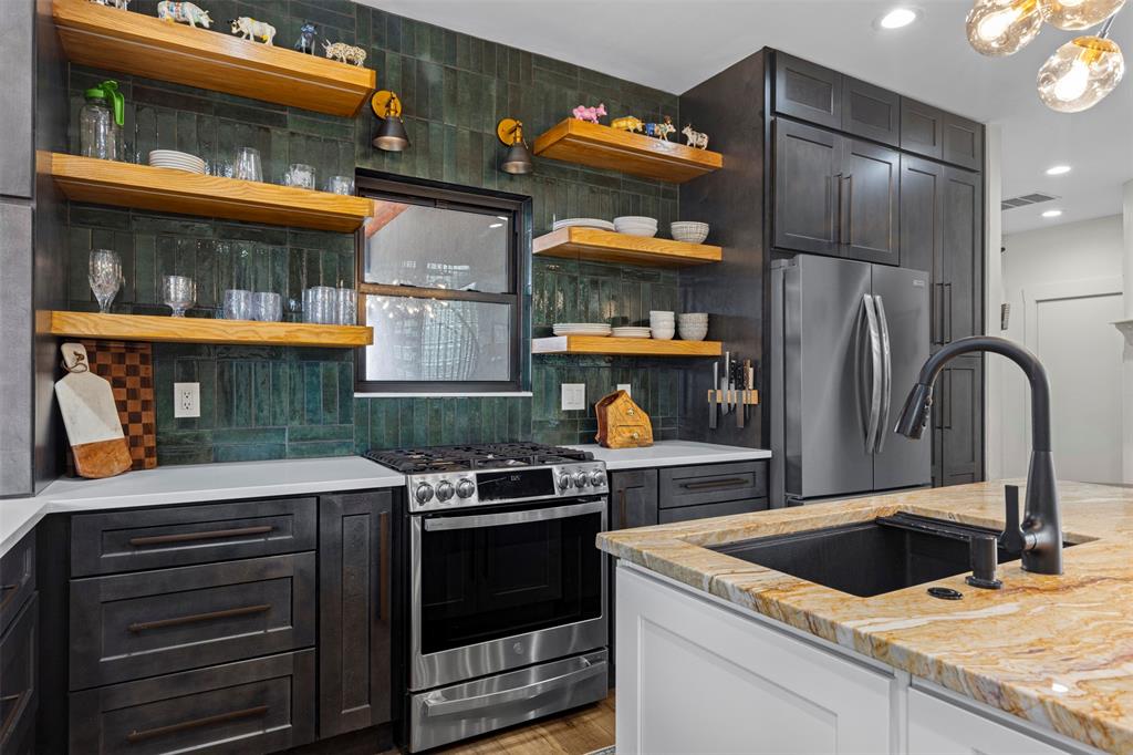 3371 Regent Drive Dallas, TX 75229 - Photo 8 of 36 New stainless steel appliances and ceiling height gorgeous green tile backsplash.