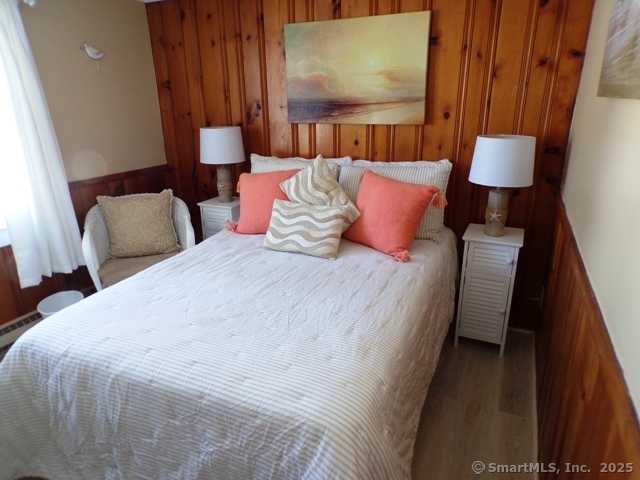 64 Washington Avenue Old Lyme, CT 06371 - Photo 15 of 25 a bedroom with a bed and a lamp with wooden floor