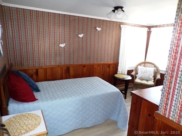 a bed room with a bed and a chair