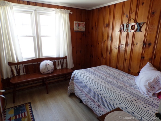64 Washington Avenue Old Lyme, CT 06371 - Photo 21 of 25 a bedroom with a bed and wooden floor