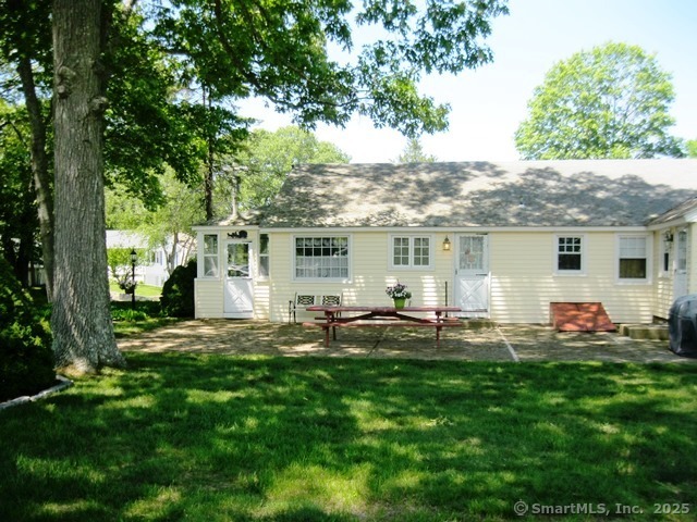 64 Washington Avenue Old Lyme, CT 06371 - Photo 3 of 25 a front view of house with a garden and patio