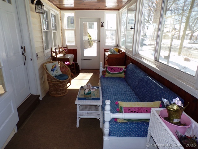 64 Washington Avenue Old Lyme, CT 06371 - Photo 8 of 25 a living room with furniture and a floor to ceiling window