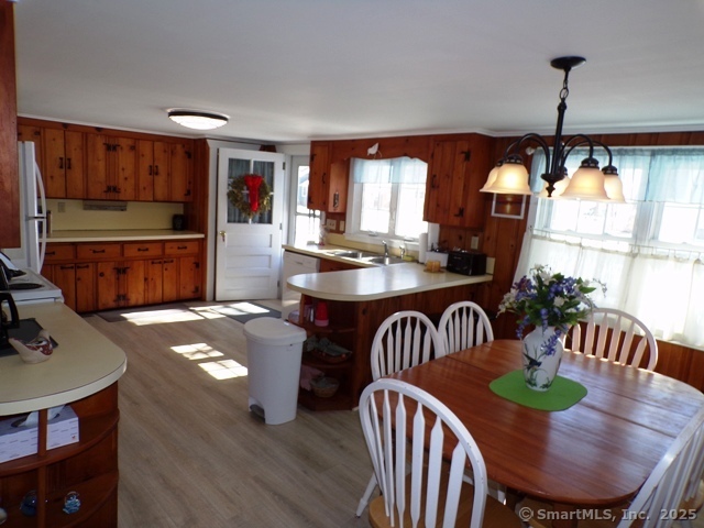 64 Washington Avenue Old Lyme, CT 06371 - Photo 9 of 25 a kitchen with a table chairs and a wooden floor