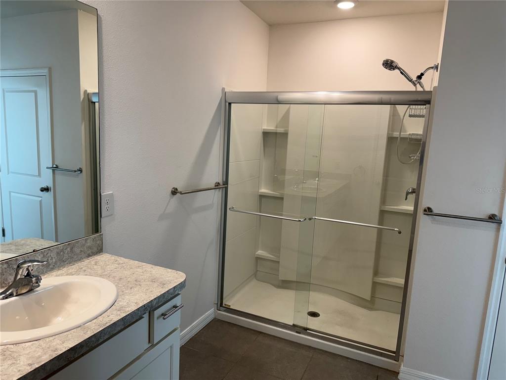 5864 Calla Lilly Drive Sarasota, FL 34232 - Photo 12 of 16 a bathroom with a shower and sink