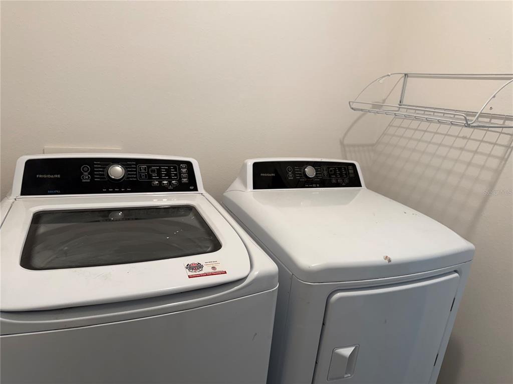 5864 Calla Lilly Drive Sarasota, FL 34232 - Photo 15 of 16 a close up view of washer and dryer