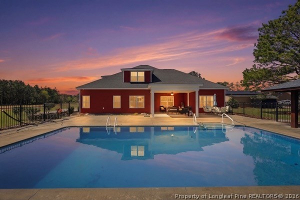 a front view of a house with swimming pool having outdoor seating