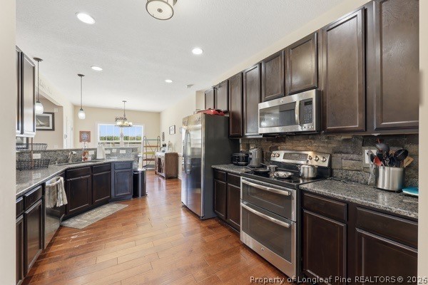 7289 Fire Dept Road Hope Mills, NC 28348 - Photo 14 of 49 a kitchen with stainless steel appliances granite countertop a refrigerator a stove top oven a sink and dishwasher