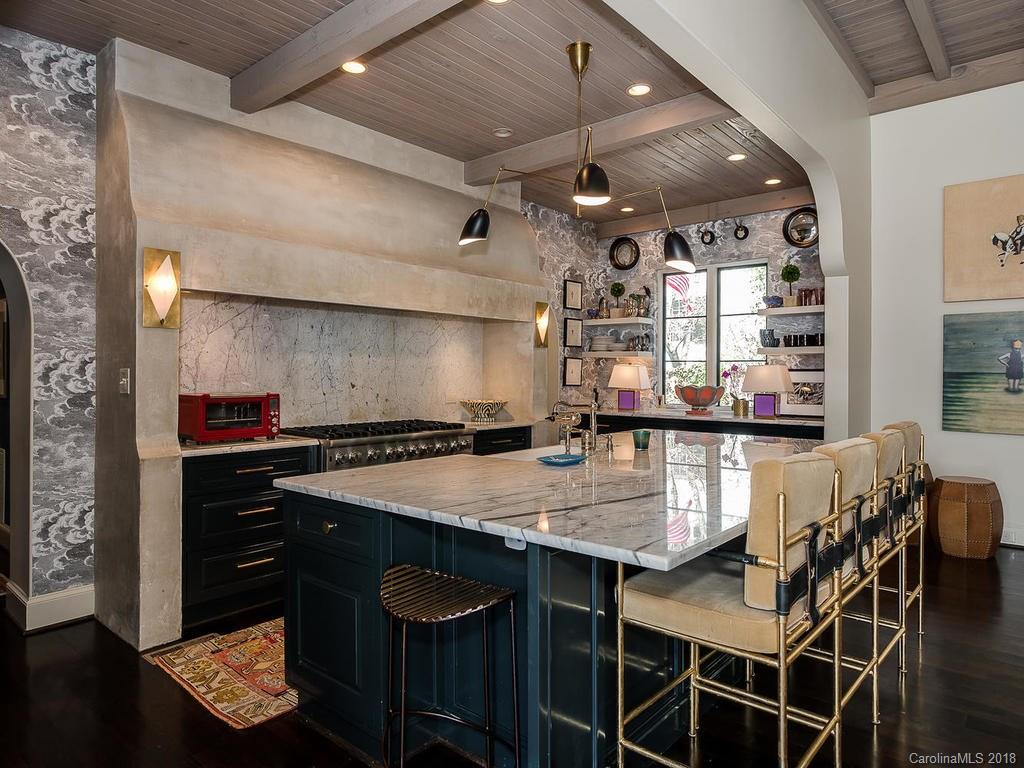 661 Colville Road Charlotte, NC 28207 - Photo 12 of 36 a kitchen with a table chairs and wooden floor