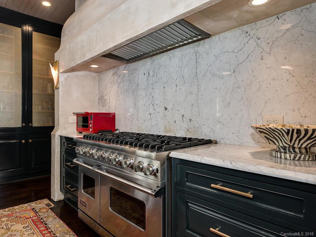 661 Colville Road Charlotte, NC 28207 - Photo 15 of 36 a stove top oven sitting inside of a kitchen